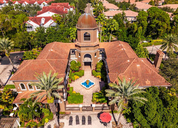 Aerial of clubhouse courtyard with fountain and surrounding palm trees