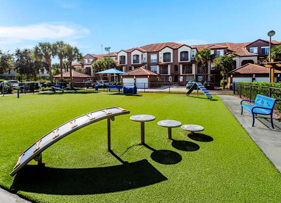Gated dog park with agility ramps, tunnels and benches