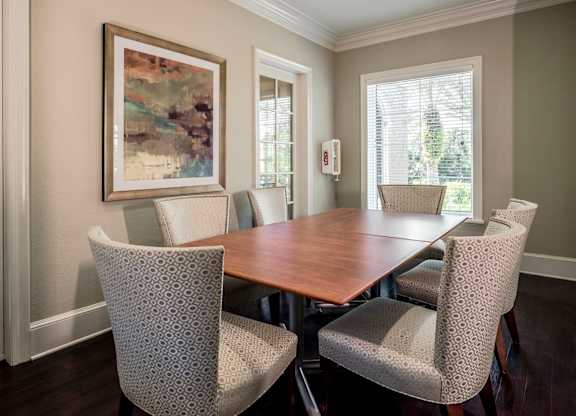 Private meeting room with a large table, comfortable chairs, and soft neutral décor.