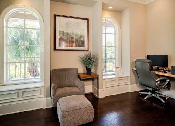 Resident business center featuring computer workstations, lounge seating, and natural light.