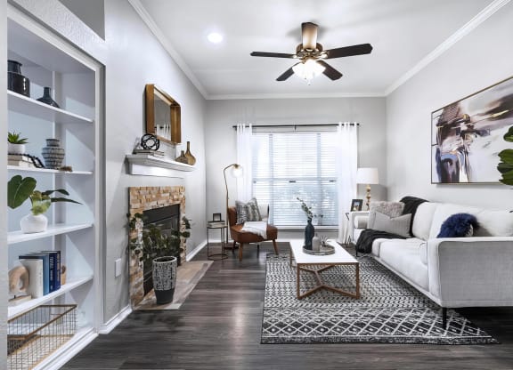 Mesa Verde Rooms Living Room with Wood Look Vinyl Flooring Fireplace Built In Shelves and Ceiling Fan