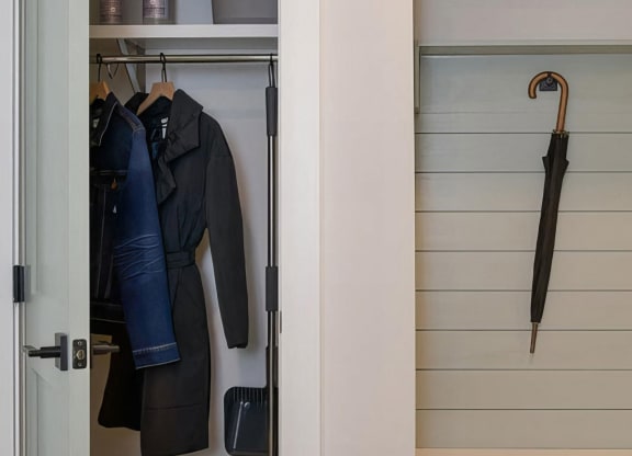 Cozy entryway foyer with hall closet and coat hooks at Novel Cary