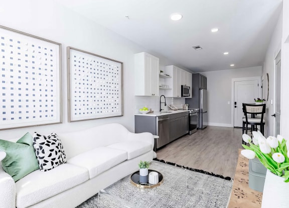 Cozy open floor plan with laminate wood floors and modern appliances at Novel Cary