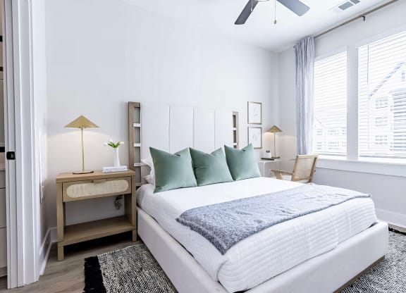 Large bedroom with oversized white trim and abundant natural light at Novel Cary