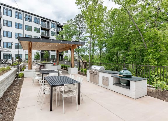 Fun and beautiful outdoor kitchen and seating areas with standard and ceramic grills at Novel Cary