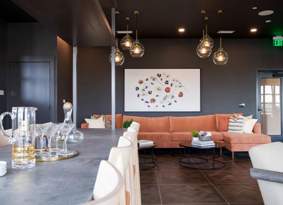 Modern bar-style seating area with comfy sofa and delicate lighting at Novel Cary