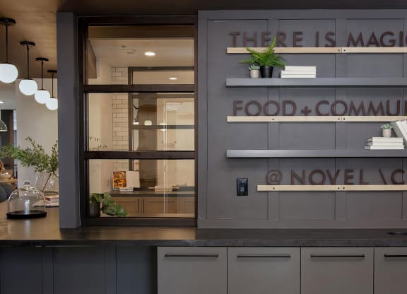 Modern coffeehouse-style social area with seating and full kitchen at Novel Cary