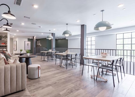 Two-story social area with abundant seating and natural light at Novel Cary