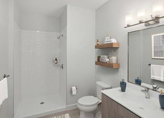 A bathroom with a toilet, sink, and shower.