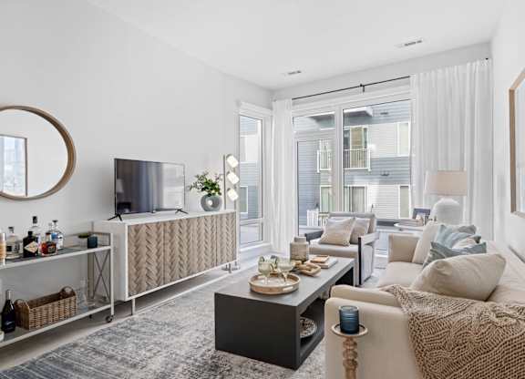 A modern living room with a large window and a flat screen TV.