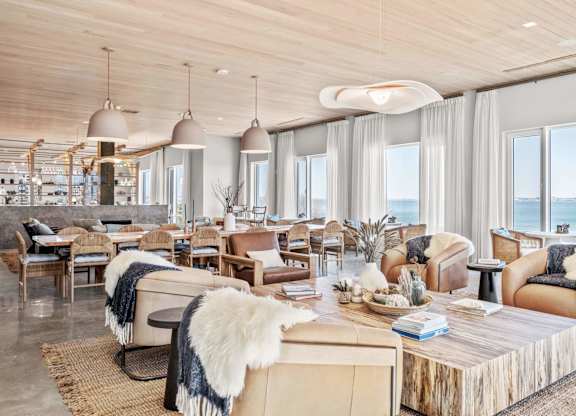 A modern living room with a view of the ocean.
