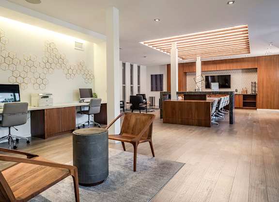 Interior tenant lounge area with computers and seating at Pearl Flagler Village