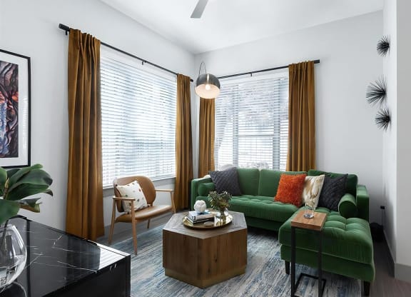 Open Layout Living Space with Statement Lighting and Floor-to-Ceiling Windows