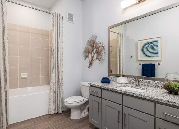 Rhythm Bathroom with Large Shower and Quartz Countertop Vanity