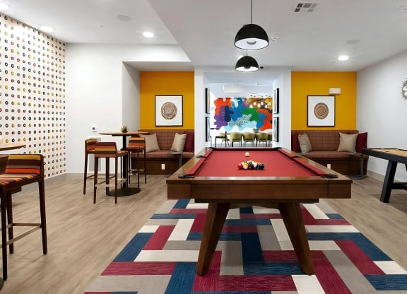 Community Game Lounge with Red Pool Table and Shuffleboard