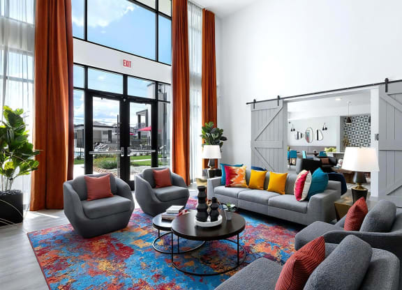 Colorful Resident Lounge Featuring High Ceilings and Floor-to-Ceiling Windows