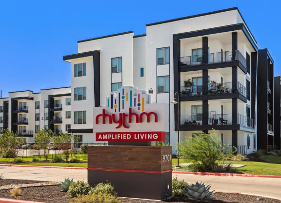 Rhythm Apartments Exterior with Prominent Community Signage