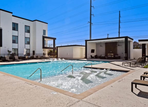 Relaxing Poolside Seating and Covered Social Areas at Rhythm Apartments