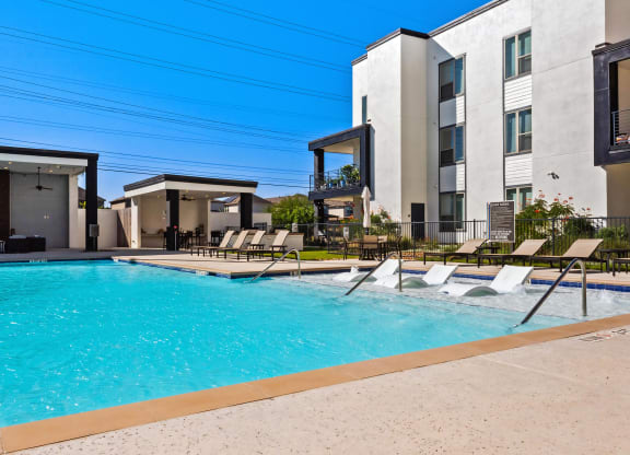 Luxury Pool Experience with Built-In Loungers and Outdoor Retreat at Rhythm Apartments