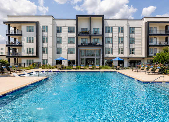 Rhythm Resort-Style Pool with Chaise Lounge Seating and Sundeck