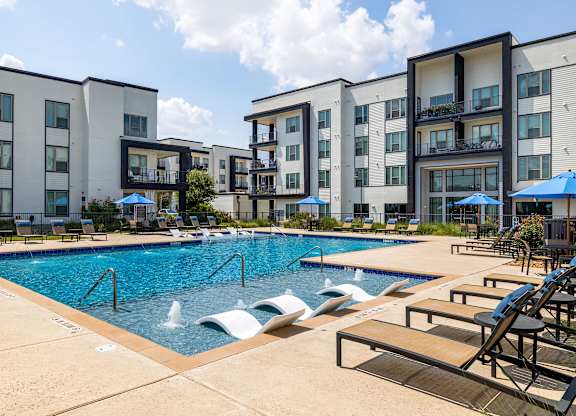Rhythm Resort-Style Pool with Chaise Lounge Seating and Sundeck