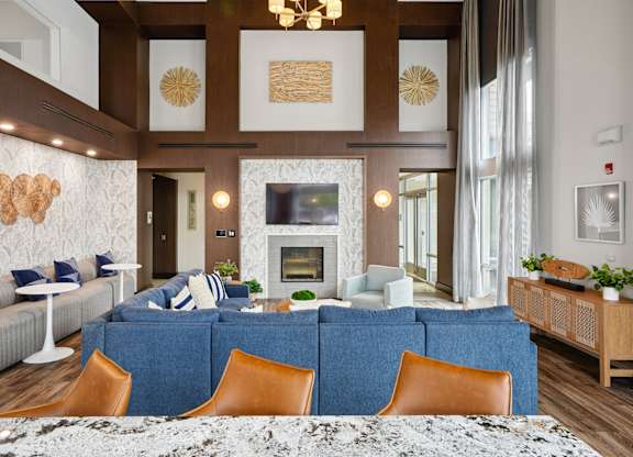 A living room with a fireplace and a blue couch.