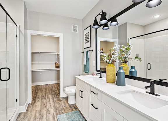A bathroom with a white sink and a mirror.