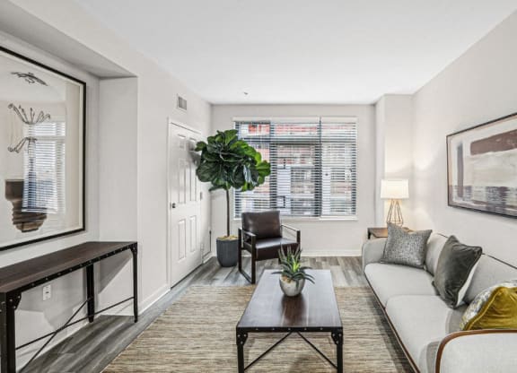 the living room of an apartment with a couch and a coffee table