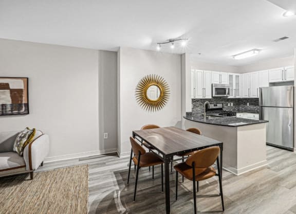 a kitchen and dining room with a table and chairs