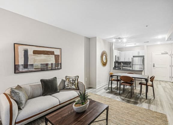 the living room of an apartment with a couch and a table