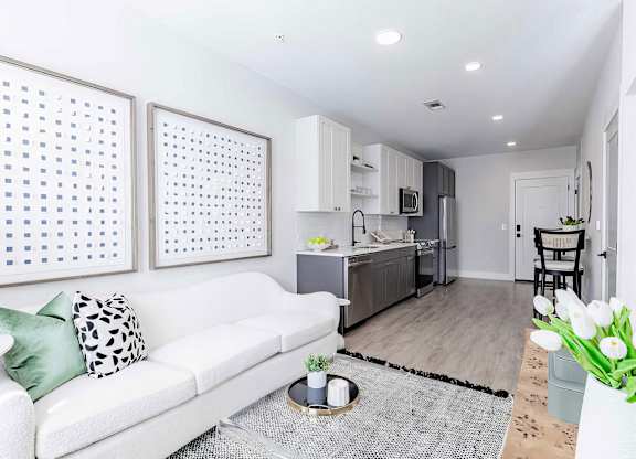 Cozy open floor plan with laminate wood floors and modern appliances at Novel Cary