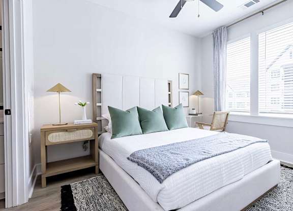 Large bedroom with oversized white trim and abundant natural light at Novel Cary
