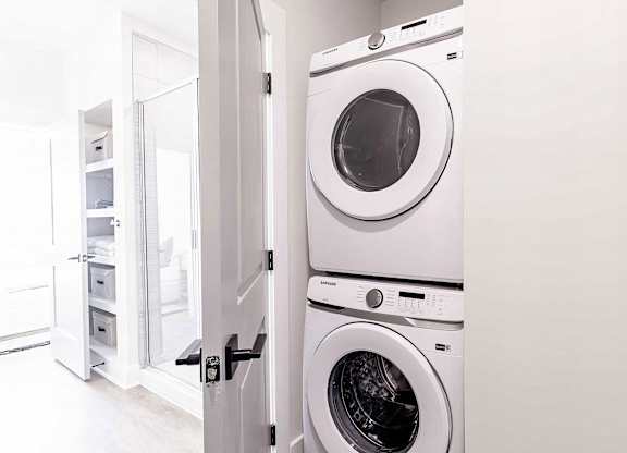 Modern bathroom with convenient in-unit washer and dryer at Novel Cary