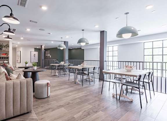 Two-story social area with abundant seating and natural light at Novel Cary