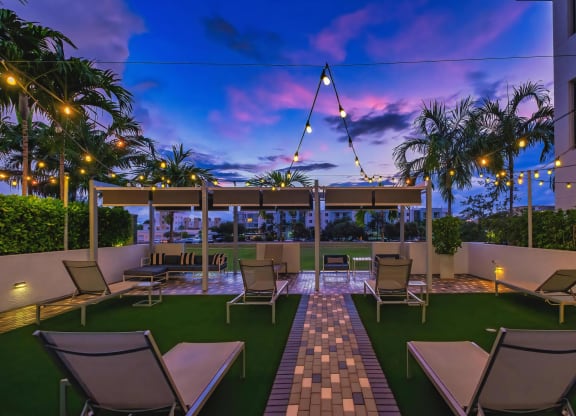 Modern Outdoor Patio with Lounge Seating and String Lights at South of Atlantic
