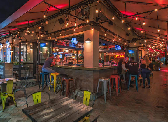 Open-Air Corner Bar with String Lights and Nightlife Vibes