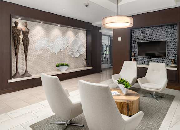 Apartment Lobby with Contemporary Seating, Sculptural Wall Art, and Mounted TV