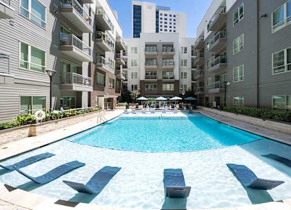 A swimming pool in the middle of apartment buildings.