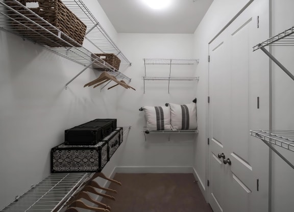 Spacious Walk-In Closet with Wire Shelving and Ample Hanging Space