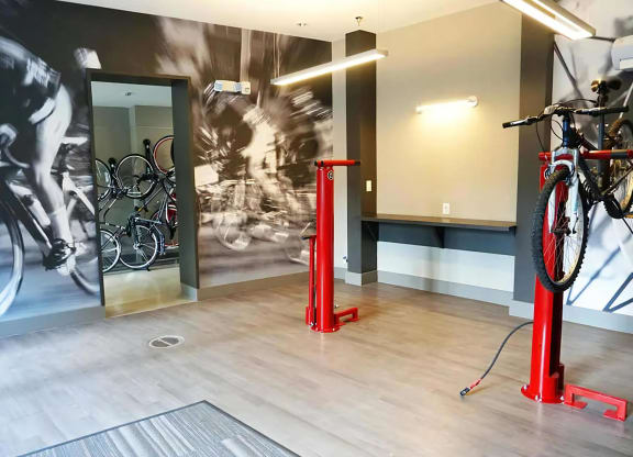 Indoor Bike Storage Room Featuring Repair Stands and Workstation