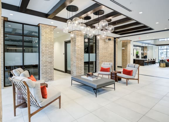 Stylish Resident Lounge with Natural Brick Columns and Pendant Lighting