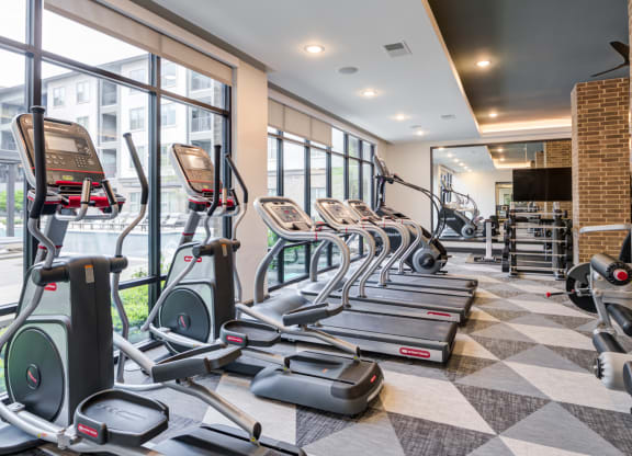 Spacious Fitness Center With Cardio Machines and Pool Views