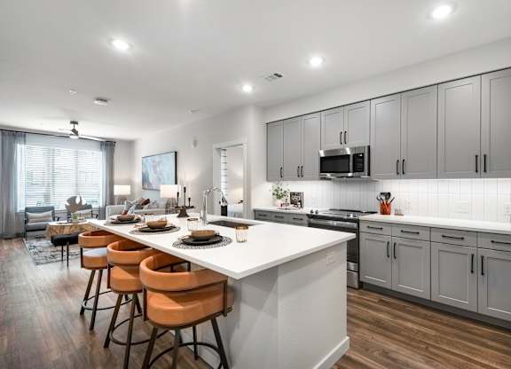 Open Concept Kitchen with Large Island, Grey Cabinets, and Bar Seating
