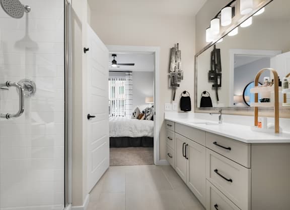 Upgraded Bathroom with Double Vanity and Frameless Walk-In Shower