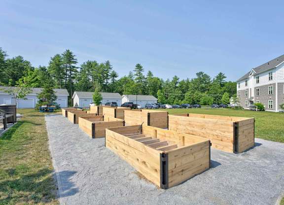 Raised garden beds beside apartment buildings at Madison at Marshfield.