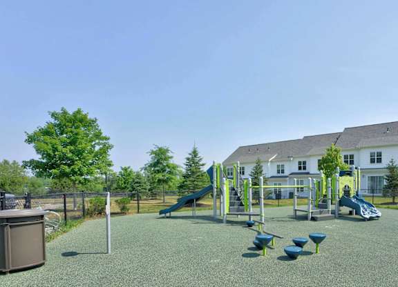 Outdoor playground with slides and climbing equipment at The Madison at Marshfield.