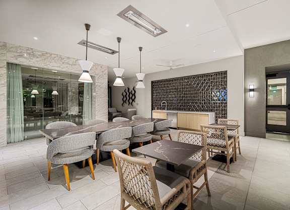 Elegant indoor lounge with marble accents, designer lighting, and flexible seating for dining or entertaining