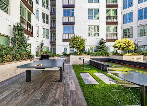 Outdoor courtyard with ping pong and bocce, offering playful spaces to connect with friends and neighbors