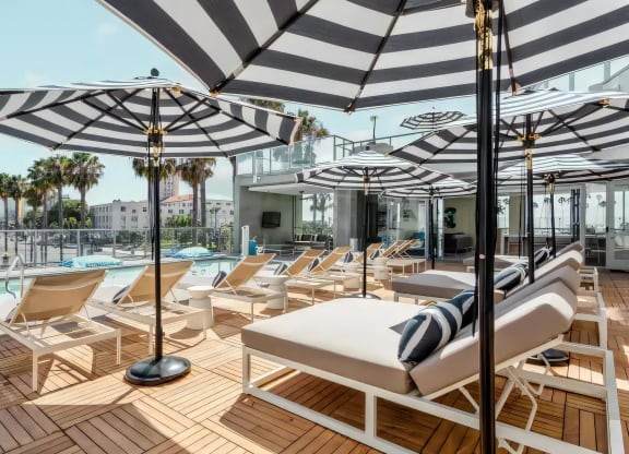 Relaxing Poolside Lounge Area with Daybeds and Outdoor Seating