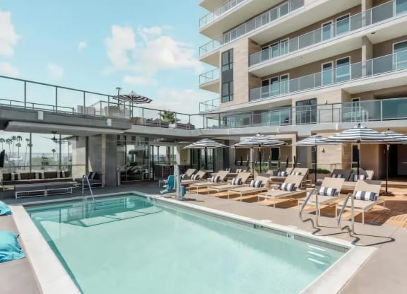 Private Pool Oasis with Lounge Chairs, Umbrellas, and Seating Areas